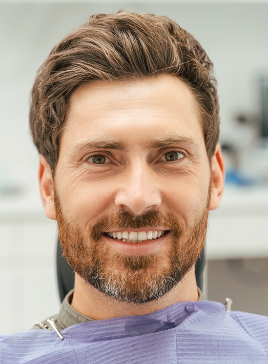 Male dental patient with beard waiting for dental checkup and cleaning in Los Angeles