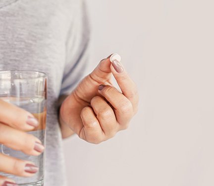 Woman taking a pill