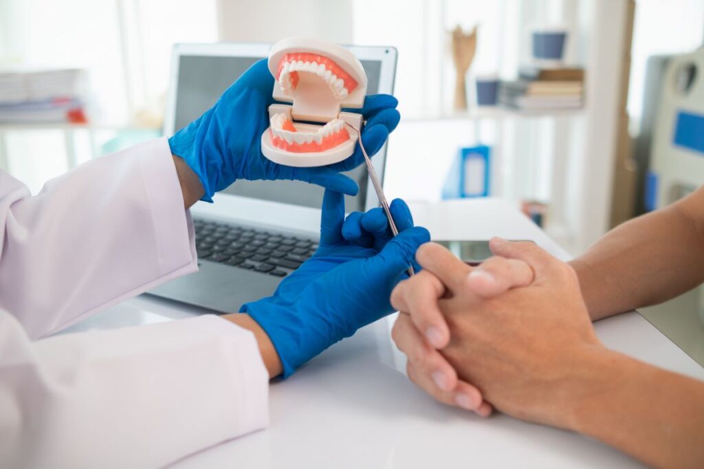 A dentist showing a patient a model of dentures